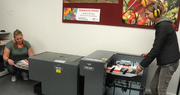 Waikato Print staff Kim Herod (l) and Gabby Langdon with the new machine