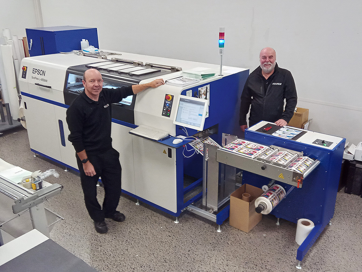 Chris Cordes (l), national production print specialist and Grant Blockley, national wide format specialist with the Epson SurePress L-4533 AW at Fujifilm Business Innovation in Auckland
