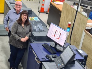 Sheryl and Dale Ertel, owners of Tainui Press Design & Print in front of the newly installed Konica Minolta AccurioPress C7100.