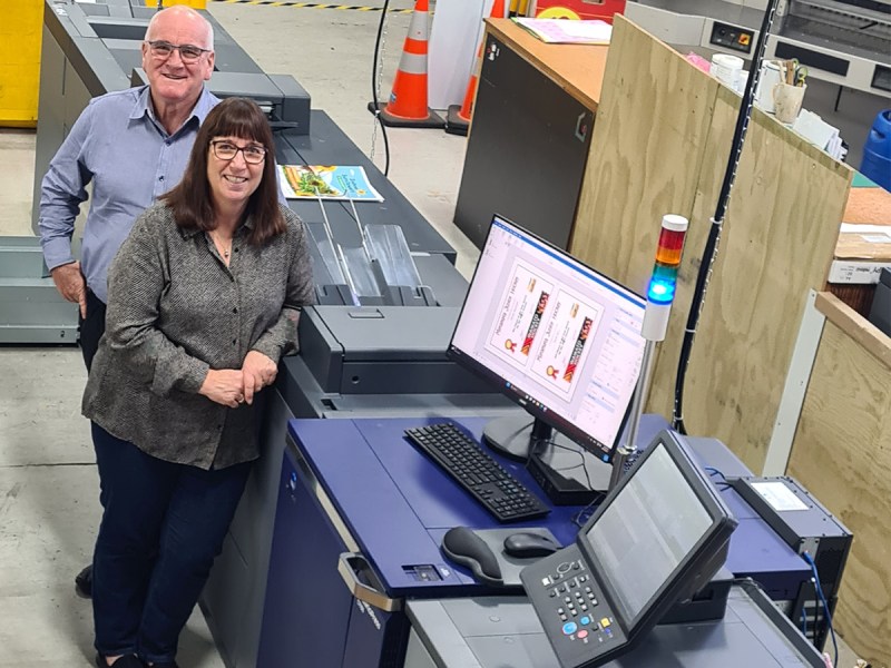 Sheryl and Dale Ertel, owners of Tainui Press Design & Print in front of the newly installed Konica Minolta AccurioPress C7100.